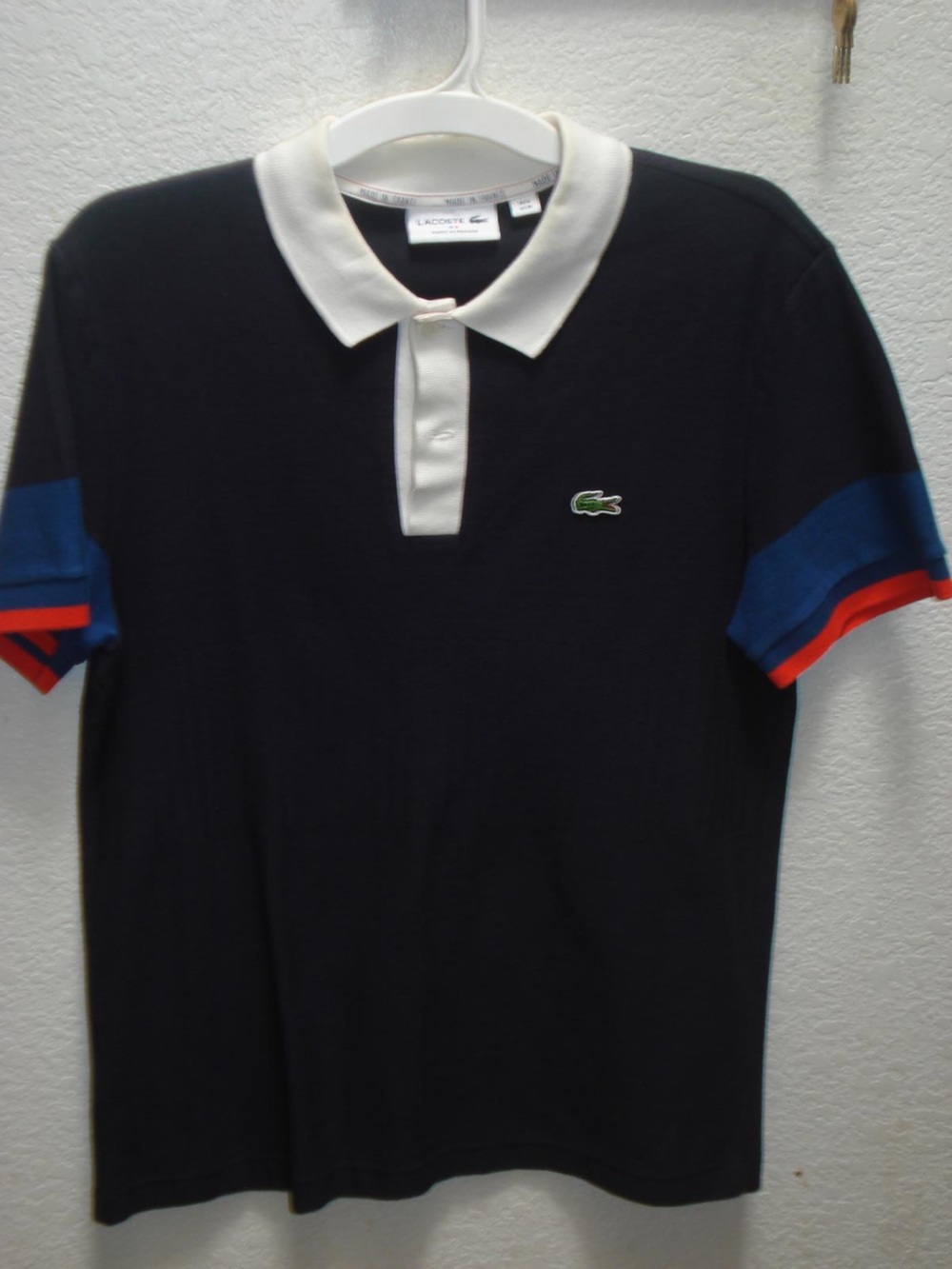 Lacoste Navy Polo with White Collar and Blue & Red Sleeve Accents